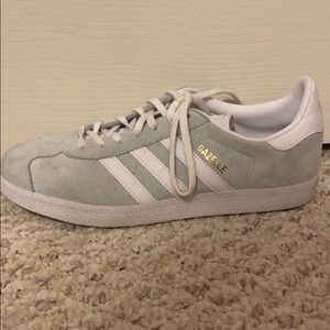 White and mint adidas gazelle shoes.